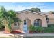 Tan house with a white door, palm trees, and red mulch at 505 Polaris Loop # 107, Casselberry, FL 32707