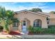 Tan house with a white door, palm trees, and red mulch at 505 Polaris Loop # 107, Casselberry, FL 32707
