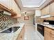 Well-lit kitchen with granite countertops and tile backsplash at 505 Polaris Loop # 107, Casselberry, FL 32707