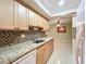 Kitchen features granite countertops and light wood cabinets at 505 Polaris Loop # 107, Casselberry, FL 32707