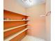 Empty pantry with orange walls and wooden shelves at 505 Polaris Loop # 107, Casselberry, FL 32707