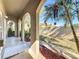 Covered porch with arched columns and tropical plants at 505 Polaris Loop # 107, Casselberry, FL 32707