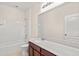 Clean bathroom, featuring a bathtub, toilet and vanity with a large mirror at 5361 Ragusa Loop, Saint Cloud, FL 34771