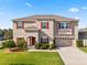 Two-story house with red shutters, attached garage, and landscaped lawn at 5361 Ragusa Loop, Saint Cloud, FL 34771