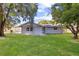 Large backyard with lush green grass and mature trees at 5851 Edouard St, Oviedo, FL 32765