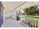 Charming front porch with white railings and a blue door at 5851 Edouard St, Oviedo, FL 32765