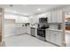 Modern kitchen featuring white shaker cabinets and stainless steel appliances at 5851 Edouard St, Oviedo, FL 32765