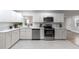 Updated kitchen with white cabinets and stainless steel appliances at 5851 Edouard St, Oviedo, FL 32765