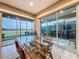 Bright dining area with glass table and sliding doors leading to the patio at 729 Alcove Dr, Groveland, FL 34736