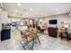 Open concept dining area with glass table and view into the living room and kitchen at 729 Alcove Dr, Groveland, FL 34736