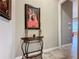 Hallway with art and a half-moon table at 729 Alcove Dr, Groveland, FL 34736