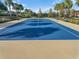 Enjoy a game on this blue tennis court at 729 Alcove Dr, Groveland, FL 34736