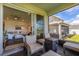 Covered porch with seating and view of living room at 7484 Catania Loop, Clermont, FL 34714