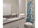 Clean bathroom with gray countertop, white cabinets, and shower with patterned curtain at 8942 Cabot Cliffs Dr, Davenport, FL 33896