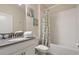 Clean and bright bathroom with shower/tub combo and decorative shower curtain at 8942 Cabot Cliffs Dr, Davenport, FL 33896