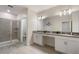 Modern bathroom with double vanity, shower stall, and tiled floors at 8942 Cabot Cliffs Dr, Davenport, FL 33896
