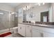 Modern bathroom with double vanity, glass shower, and white cabinets at 8942 Cabot Cliffs Dr, Davenport, FL 33896