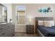 Modern bedroom with gray wood furniture and a large window at 8942 Cabot Cliffs Dr, Davenport, FL 33896