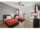 ' bedroom with two twin beds, Mickey Mouse decor, and ceiling fan at 8942 Cabot Cliffs Dr, Davenport, FL 33896