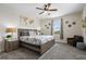 Spacious bedroom featuring a king-size bed, ceiling fan, and comfortable seating area at 8942 Cabot Cliffs Dr, Davenport, FL 33896