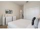 A bedroom featuring white dresser, wall-mounted TV, and closet with white doors at 8942 Cabot Cliffs Dr, Davenport, FL 33896