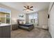 A cozy bedroom featuring a bed, nightstand, dresser, and wall-mounted TV at 8942 Cabot Cliffs Dr, Davenport, FL 33896