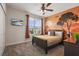 Bedroom featuring an orange accent wall with a nature-themed mural at 8942 Cabot Cliffs Dr, Davenport, FL 33896