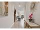 Inviting entryway with contemporary art, elegant console table, and view to living area at 8942 Cabot Cliffs Dr, Davenport, FL 33896