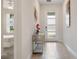 Bright foyer with modern decor, tile flooring, and view to a bedroom at 8942 Cabot Cliffs Dr, Davenport, FL 33896