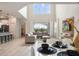 Spacious great room with high ceilings, large windows, comfortable sectional sofa, and view of the backyard at 8942 Cabot Cliffs Dr, Davenport, FL 33896