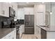 Modern kitchen with stainless appliances, dark tile backsplash, and plenty of counter space at 8942 Cabot Cliffs Dr, Davenport, FL 33896