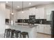 Modern kitchen with white cabinets, dark tile backsplash, and stainless steel appliances at 8942 Cabot Cliffs Dr, Davenport, FL 33896