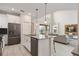 View of the kitchen island with open access to the living room at 8942 Cabot Cliffs Dr, Davenport, FL 33896