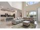 Open-concept living area with kitchen, high ceilings, and view to the pool at 8942 Cabot Cliffs Dr, Davenport, FL 33896
