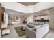 Open-concept living and dining area with high ceilings, contemporary furniture, and tile floors at 8942 Cabot Cliffs Dr, Davenport, FL 33896