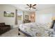 Main bedroom with comfortable seating area and TV mounted on the wall at 8942 Cabot Cliffs Dr, Davenport, FL 33896