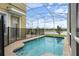 Screened-in pool with a safety fence and water view at 8942 Cabot Cliffs Dr, Davenport, FL 33896