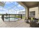 Screened patio with a pool, safety fence, and seating area at 8942 Cabot Cliffs Dr, Davenport, FL 33896