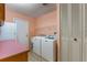 Laundry room with washer, dryer, and pink countertop at 1098 Park Dr, Casselberry, FL 32707