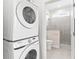 Bathroom with walk-in shower and stackable washer/dryer at 12071 Lakeshore Way, Oxford, FL 34484