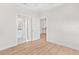 Simple bedroom with wood floors and access to a bathroom at 12071 Lakeshore Way, Oxford, FL 34484