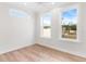 Bright bedroom with hardwood floors and large windows at 12071 Lakeshore Way, Oxford, FL 34484