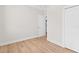 Bedroom with wood floors and access to laundry at 12071 Lakeshore Way, Oxford, FL 34484