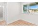 Light-filled bedroom with wood floors and a view at 12071 Lakeshore Way, Oxford, FL 34484