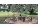 Relaxing fire pit area with wooden chairs at 12071 Lakeshore Way, Oxford, FL 34484