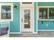 White front door with glass panels and black hardware, welcoming entryway at 12071 Lakeshore Way, Oxford, FL 34484