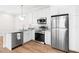 Modern white kitchen with stainless steel appliances at 12071 Lakeshore Way, Oxford, FL 34484