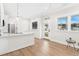Bright living room with hardwood floors and kitchen island at 12071 Lakeshore Way, Oxford, FL 34484