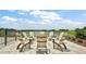 Lakeside patio with chairs around a fire pit at 12071 Lakeshore Way, Oxford, FL 34484