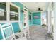Relaxing screened porch with rocking chairs and outdoor TV at 12071 Lakeshore Way, Oxford, FL 34484